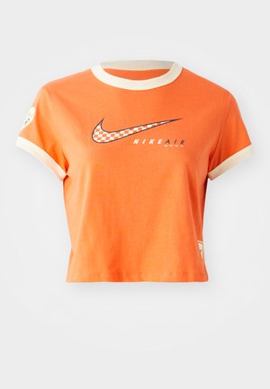 Orange cropped t-shirt made of cotton, featuring contrasting cream-colored ribbed neckline and cuffs, with a black checkered logo on the front.