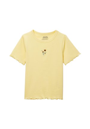 T-shirt côtelé manches courtes jaune pâle avec bords festonnés et petit motif de tournesol brodé au centre devant.