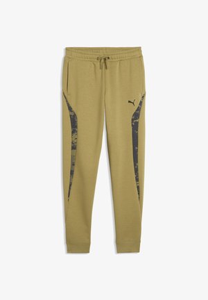 Lysebrune Puma joggingbukser med elastisk talje, snøre, sidelommer og mørke mønstrede lodrette striber på benene.