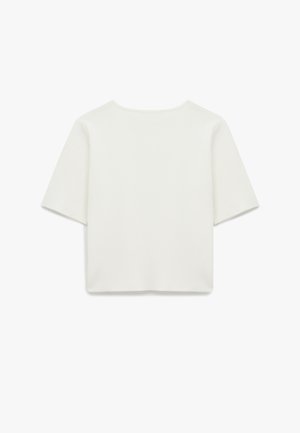 Short-sleeve, round-neck white top made from a soft, textured fabric; features a straight cut and minimal stitching details on the seams.