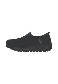 Schwarze Slipper aus strukturiertem Mesh-Obermaterial, mit runder Zehenpartie und einer dicken, gepolsterten Gummisohle für Komfort. Minimale Markeninformationen sind vorhanden.