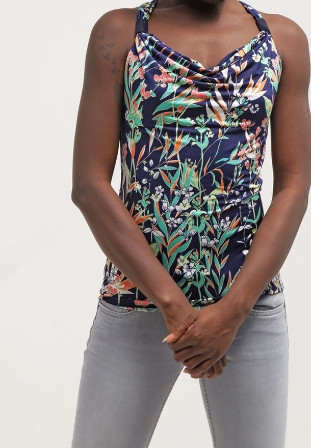 Floral-patterned sleeveless top in dark navy with a gathered neckline; made of smooth fabric. Paired with light gray fitted jeans.