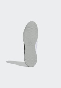 Crna i siva atletska đon s teksturiranom površinom, s Adidas logotipom utisnutim u središtu.