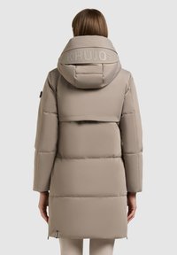 Beige, puffy parka jacket featuring a large hood, horizontal stitch lines, and logo detailing on the back. Smooth fabric, knee length.