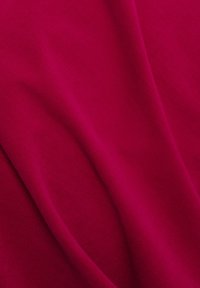 Fuchsia fabric featuring a smooth texture with subtle ribbing, displaying gentle folds that highlight its thickness and softness.
