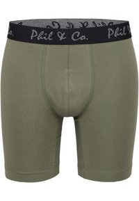 Olivově zelené boxerky s černým elastickým pasem a šedým logem. Měkká látka s hladkým povrchem a přiléhavým střihem.