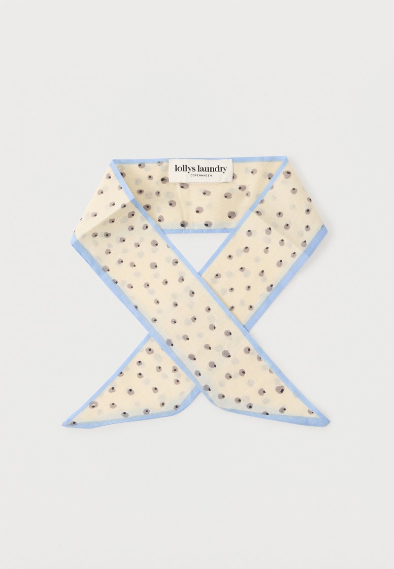 Ανοιχτό μπεζ κασκόλ με μαύρα πουά και ανοιχτομπλε άκρα, διπλωμένο με ορατή ετικέτα επωνυμίας "lollys laundry Copenhagen".