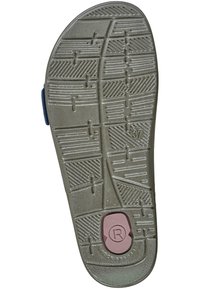 Suola di una scarpa con superficie in gomma testurizzata, caratterizzata da un motivo di battistrada. Il colore è principalmente beige con un accento circolare rosa vicino al tallone.