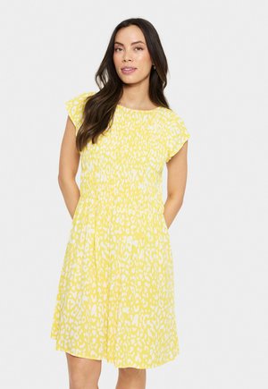 Yellow dress with a leopard print pattern, short flutter sleeves, and a smocked waist for a fitted silhouette. Lightweight fabric.