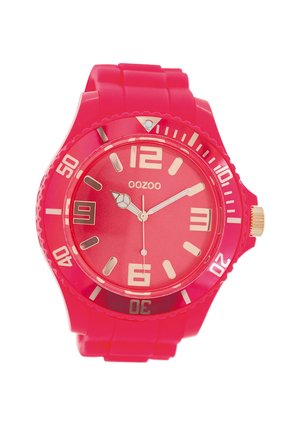 Montre-bracelet rose vif avec un bracelet en silicone, un large cadran, un verre transparent, des accents dorés et des index d'heure audacieux dans des couleurs contrastées.