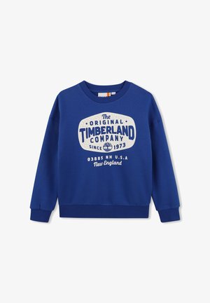 Niebieska bluza z okrągłym dekoltem, z białym logo Timberland i tekstem: "The Original Timberland Company since 1973, New England, U.S.A."
