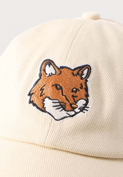 Μπεζ υφασμάτινο καπέλο με κεντημένο σχέδιο κεφαλής αλεπούς σε πορτοκαλί και λευκό, τοποθετημένο στο κέντρο της μπροστινής επιφάνειας.