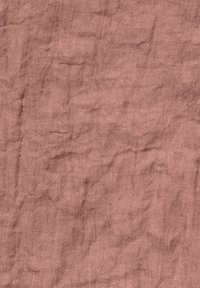Pink linen fabric with a textured, wrinkled surface. The material appears soft and natural with a subtle sheen, displaying irregular patterns.