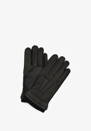 Paar schwarze Lederhandschuhe mit gerippten Strickbündchen und dekorativen Nähten auf dem Handrücken.