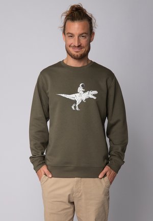Dark green sweatshirt in a soft fabric, featuring a white graphic of an astronaut riding a dinosaur. Long sleeves and a round neckline.
