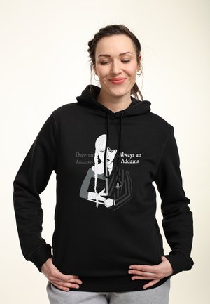 Black hoodie featuring graphic design of two characters; one with braids, holding a book, and text "Once an Addams, Always an Addams."