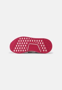 Adidas shoe outsole featuring a bright pink rubber material with hexagonal cutouts, textured pattern, and logo detail in the center.