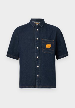 Short-sleeve denim shirt in dark blue with a button-up front, single chest pocket, and orange label detail. Features contrast stitching.