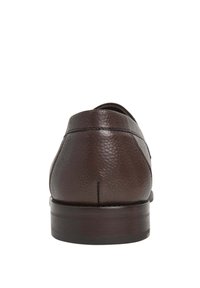 Zapato de vestir de cuero texturizado marrón oscuro visto desde atrás, con un tacón bajo y costuras visibles a lo largo del borde superior.