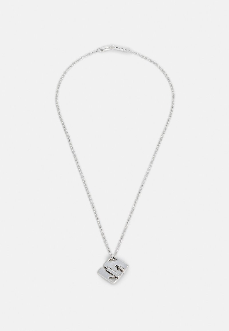 Silver chain necklace featuring a textured, abstract pendant with geometric shapes, adding depth to its minimalist design.