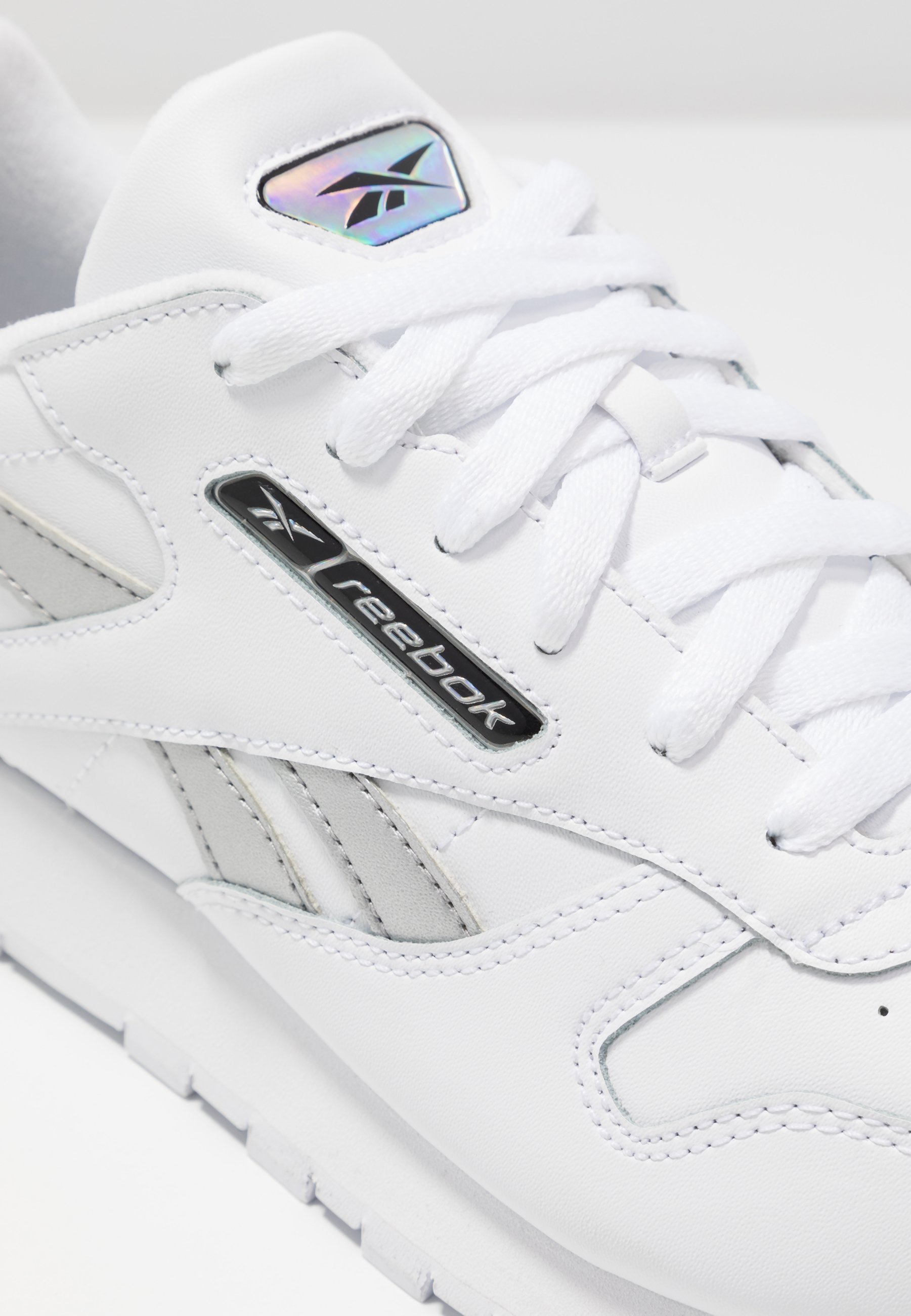 white and silver reebok