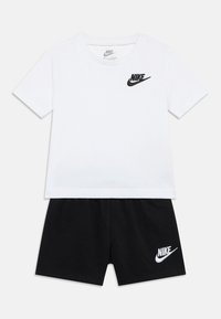 Σετ δύο τεμαχίων που αποτελείται από ένα λευκό βαμβακερό T-shirt με μαύρο λογότυπο Nike και μαύρο σορτς, με κεντημένο λογότυπο Nike στο τελείωμα.