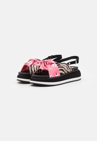Pink floral-patterned strap sandals with a zebra print accent, featuring a black base and white sole, designed for comfort and style.