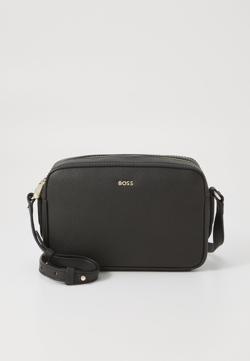 Bolsa crossbody de couro preto com acabamento texturizado, fecho de zipper, alça ajustável e logótipo metálico na frente.