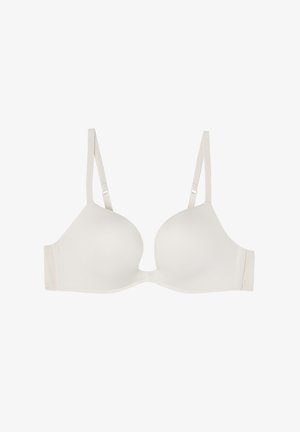 Lichtbeige beha met gladde, gevormde cups, verstelbare bandjes en naadloze randen voor comfort. Eenvoudig ontwerp geschikt voor dagelijks gebruik.