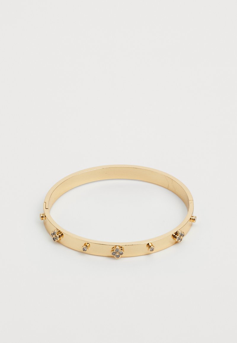 Kuldmetallist käevõru, millel on väiksed dekoratiivsed lilled ja nupud. Sile viimistlus koos sujuva, ümmarguse disainiga. Avaneb küljelt.