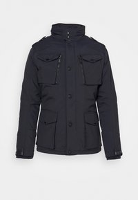Veste d'hiver noire avec quatre poches sur le devant, deux à boutons et deux zippées, fermeture par boutons et zip, et un col montant avec boutons-pression.