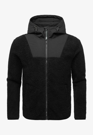Giacca in pile nera con cappuccio, caratterizzata da un pannello superiore in tessuto liscio, chiusura con zip e corpo testurizzato. Cappuccio regolabile con cordini.