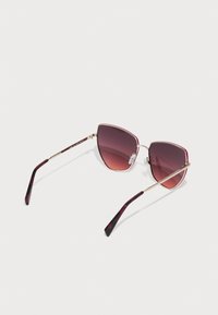 Cat-eye sunglasses with gradient purple lenses, gold metal frame, and burgundy patterned arms. Lightweight design with adjustable nose pads.