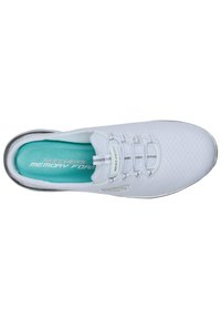 White sneaker with a textured upper, elastic laces, and a teal memory foam insole. Features a silver accent along the sole.