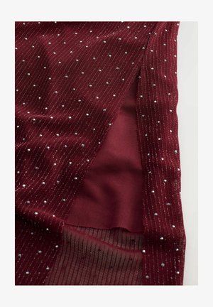 Burgundy fabric with textured ribbing features scattered silver embellishments. Includes a sheer section and a solid underlying layer.