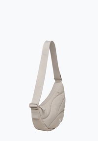 Beige, quiltet skuldertaske med en bred rem og justerbar spænde. Glat tekstur, rund form, med en subtil logo-detalje.