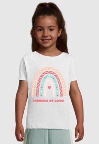 White cotton t-shirt featuring a multicolored rainbow graphic with hearts and decorative borders, text reads "RAINBOW OF LOVE!" in bold pink.