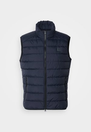 Donkerblauwe geïsoleerde puffer vest met hoge kraag, ritssluiting aan de voorkant en twee zijzakken. Voorzien van een horizontaal gestikt ontwerp en een logo patch.