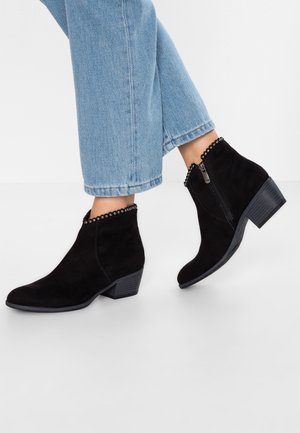Stivali alla caviglia in suede nero con tacco a blocco testurizzato, bordo decorativo in perline nella parte superiore e zip laterale per una facile indossabilità.