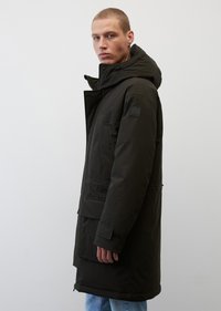 Langer schwarzer Parka mit Kapuze, ausgestattet mit einem Reißverschluss, mehreren Taschen und einem elastischen Bund. Glatte Textur und minimaler Markenaufdruck am Ärmel.