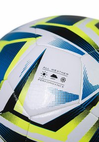White soccer ball featuring blue, black, and neon yellow geometric patterns. Text "ALL WEATHER PERFORMANCE" displayed on surface.
