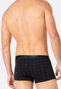 Boxers en coton noirs à conception ajustée, avec un motif à pois en rouge, bleu et blanc. Tissu doux et ceinture élastique.