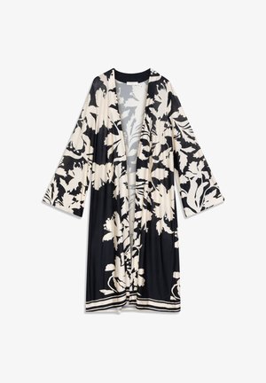 Kimono floral noir et beige avec manches larges, devant ouvert, bordure noire et design fluide. Présente de grandes impressions botaniques et une texture douce.