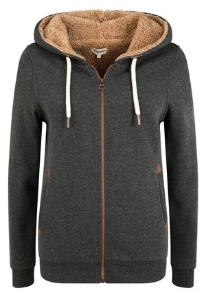 Hoodie zippé gris foncé avec une capuche doublée en polaire beige, cordons de tirage crème et détails marron sur les poches. Tissu doux avec des poignets côtelés.