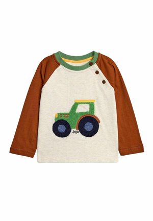 Long-sleeve shirt with beige body and brown sleeves, featuring a green tractor embroidery with blue wheels and yellow accents. Two buttons on the shoulder.