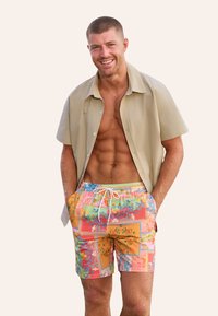 Korte mouwen beige shirt over kleurrijke gebloemde zwemshorts met een trekkoord in de taille. Textuurstof, ontspannen pasvorm.