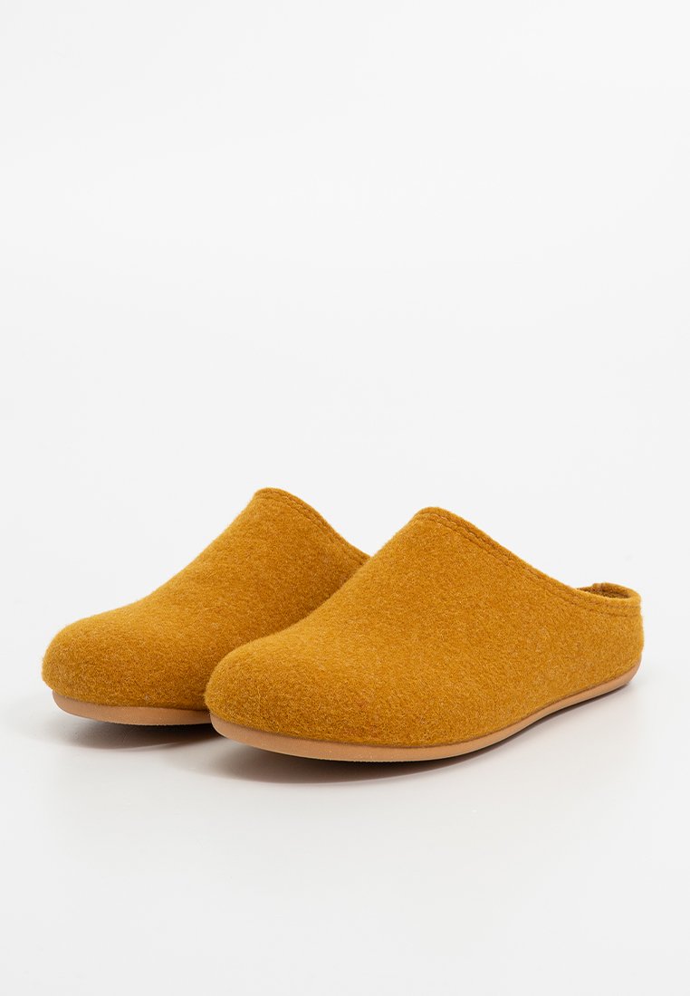 Senfgelbe Filzclogs mit einer glatten, runden Spitze und offenem Rücken. Braune Gummisohlen bieten Grip und Haltbarkeit und heben ein minimalistisches Design hervor.