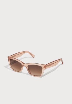 Rose-tinted sunglasses with a transparent plastic frame and brown gradient lenses. Square shape; temple arms with subtle sparkles.