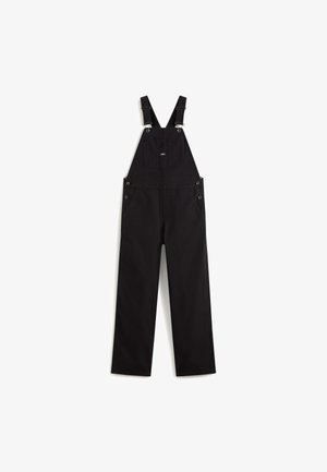 Schwarze Latzhose aus strapazierfähigem Stoff, mit verstellbaren Schultergurten, einer Fronttasche und Seitentaschen mit Metallknöpfen.