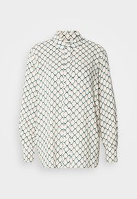 Long-sleeve shirt in cream with a geometric blue pattern. Features a pointed collar and a button-down front. Soft fabric texture.